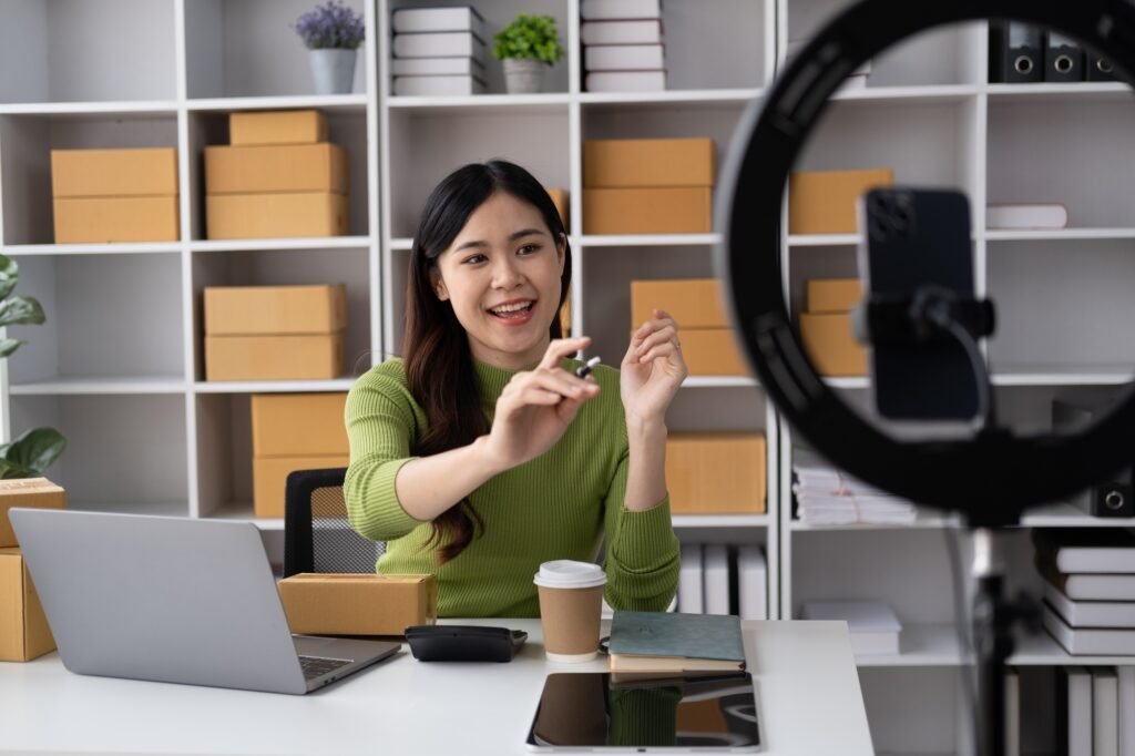 Young online shopping shop owner livestreaming and interacting with her customer.